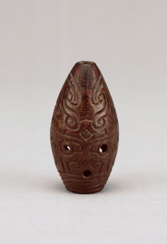 Whistle with carved animal-mask motif